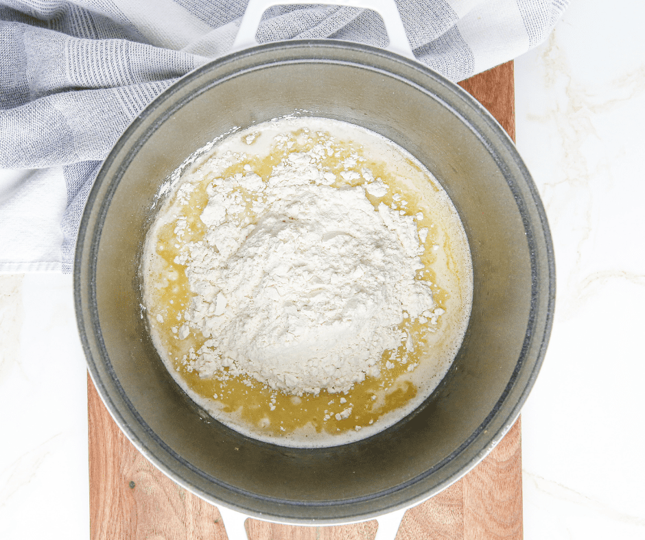 Preparing an air fryer tray with parchment paper and boiling water, butter, and salt in a saucepan.