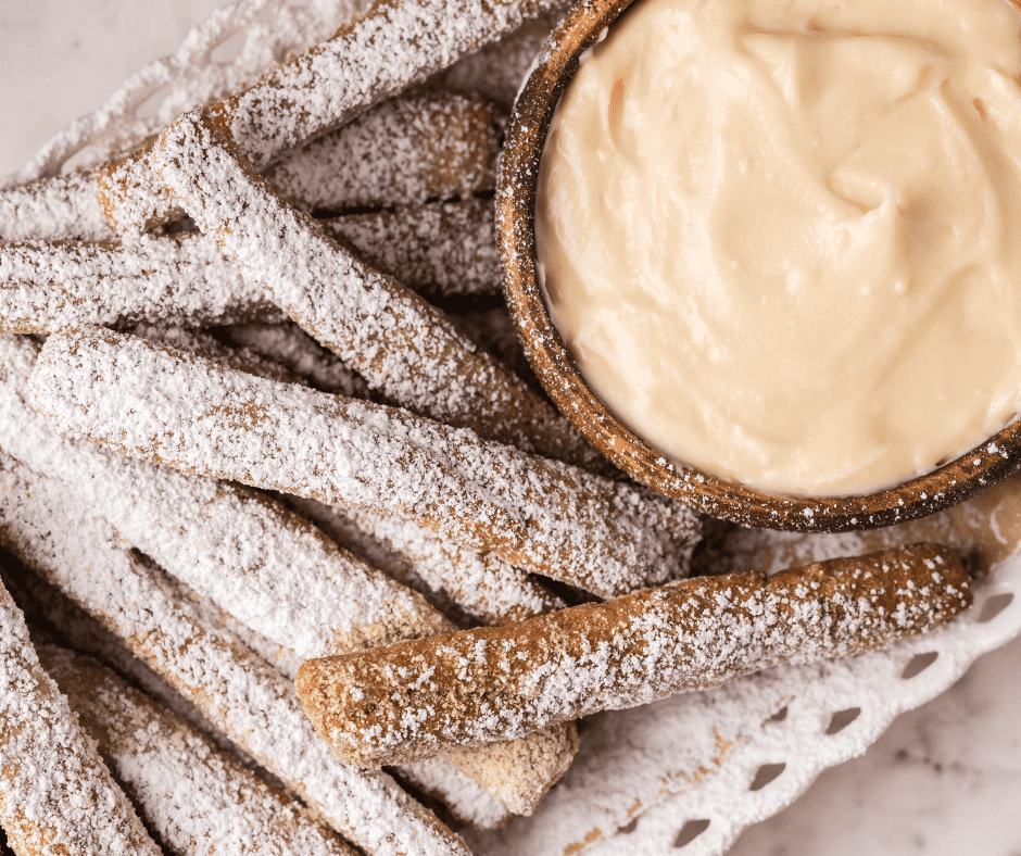 Air Fryer Funnel Cake Fries, golden and crispy, dusted with powdered sugar, ready to enjoy as a sweet treat.