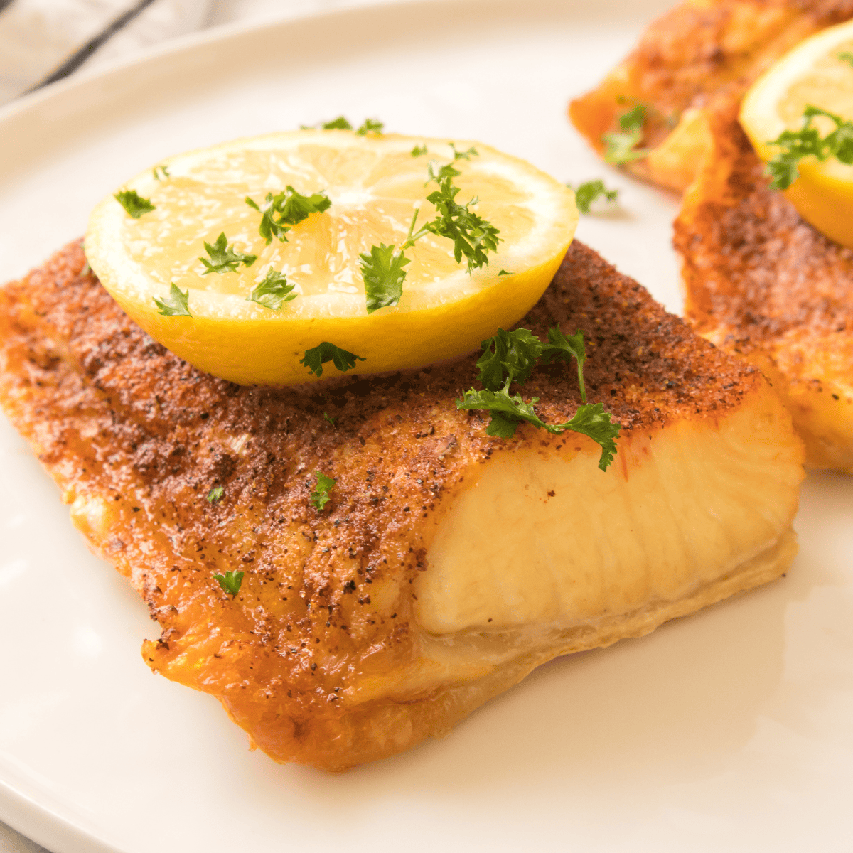 Air Fryer Parmesan-Crusted Halibut cooked to golden perfection with a crispy outer layer and flaky, tender inside.