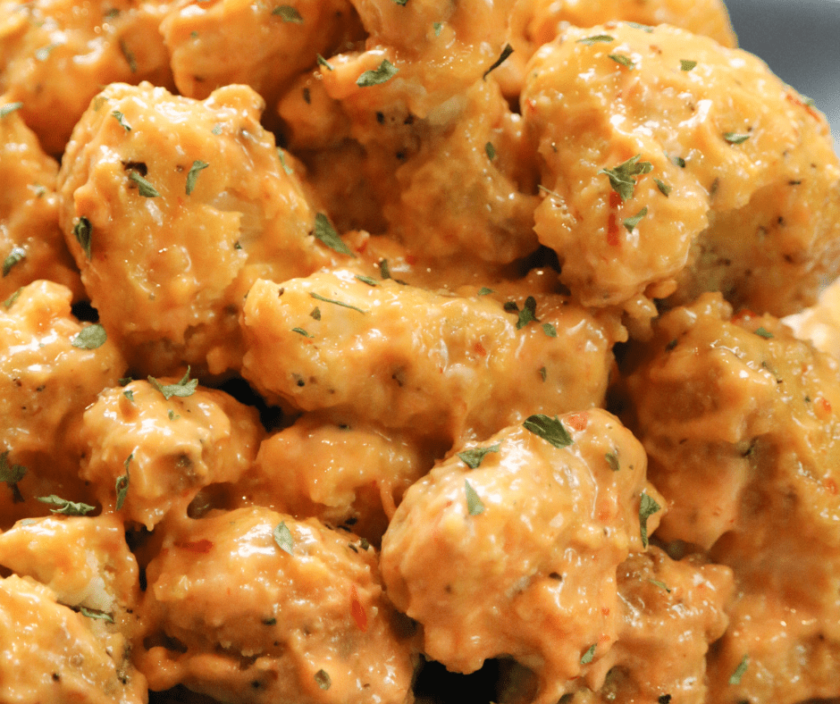 Mixing mayonnaise, sweet chili sauce, honey, and hot sauce to make Bang Bang sauce, then tossing the crispy cauliflower in the sauce for a flavorful finish.