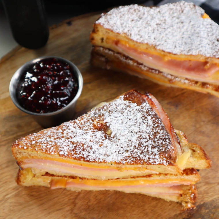Easy air fryer Monte Cristo sandwich with ham, turkey, melted cheese, and powdered sugar