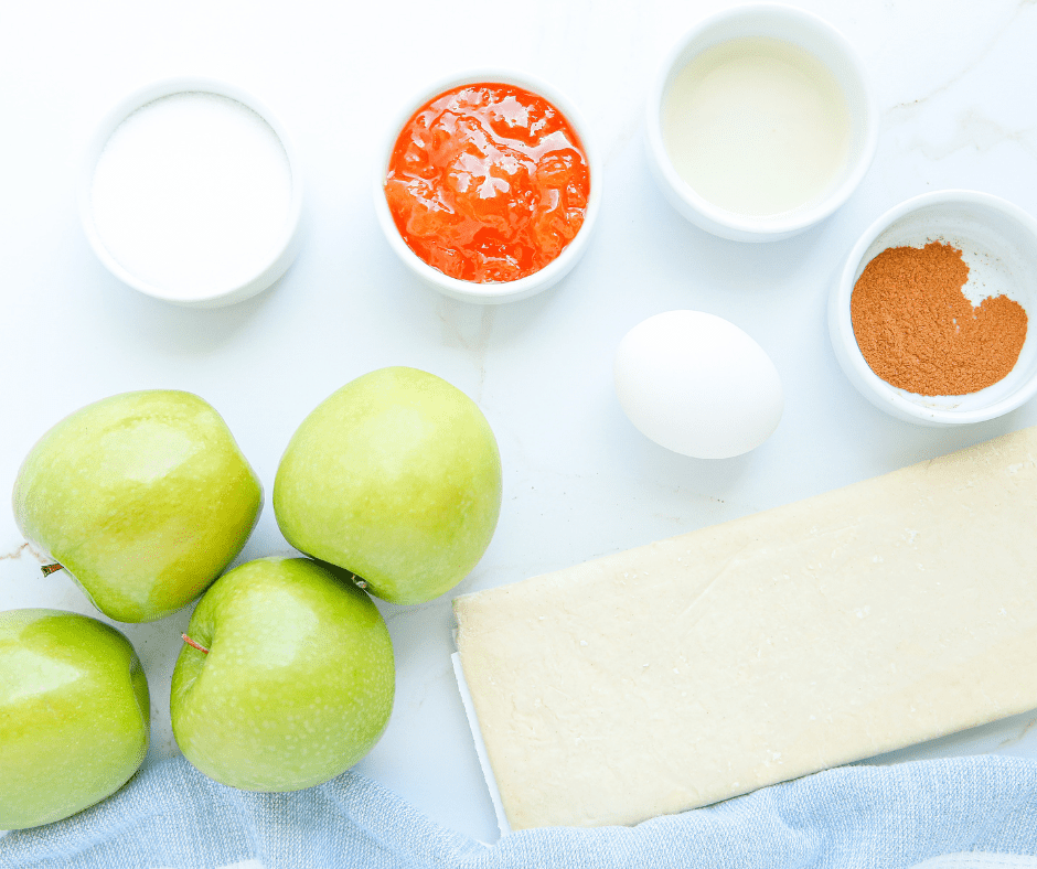 Ingredients for air fryer puff pastry apple tarts laid out on a table