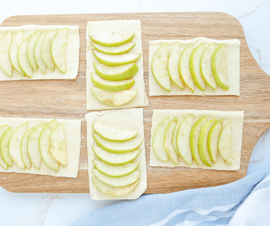 Puff pastry rectangles topped with sliced cinnamon apples, not overfilled