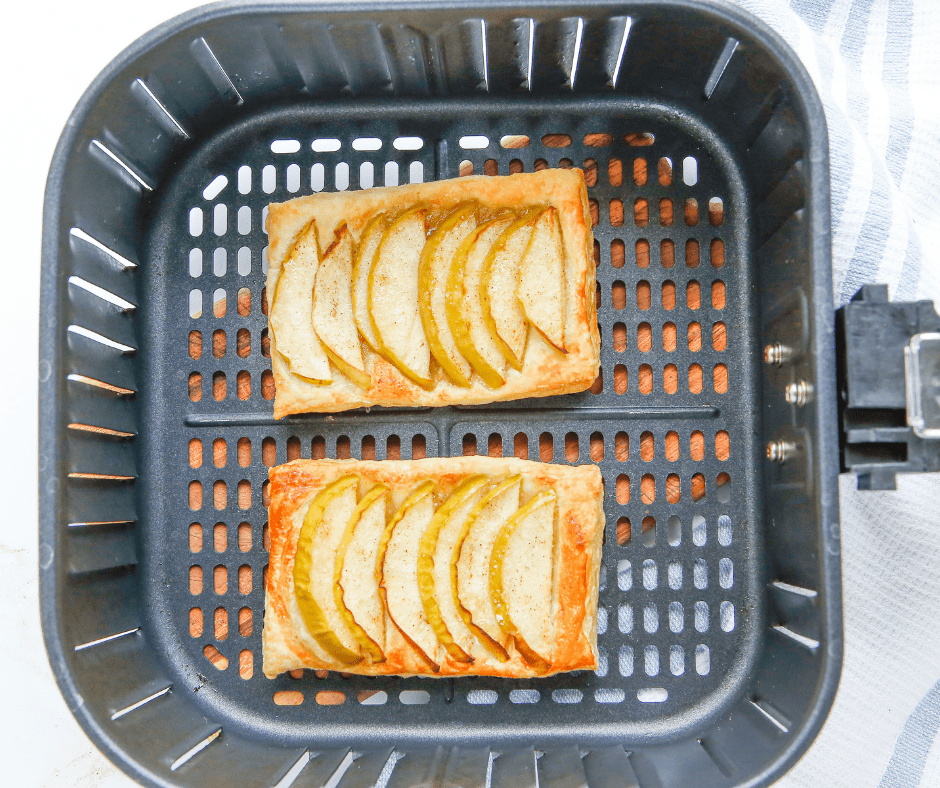 Puff pastry apple tarts cooking in the air fryer at 400°F