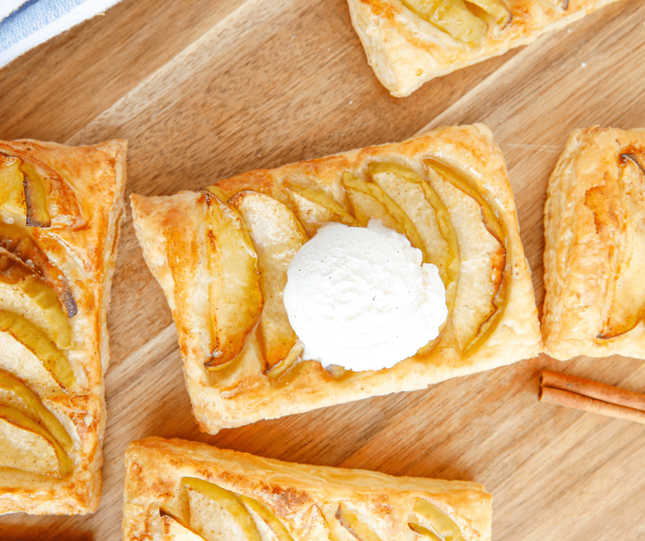 Air fryer apple tarts brushed with apricot glaze on a white plate