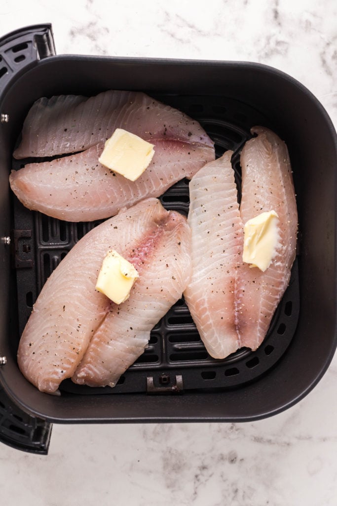 Add garlic cloves, minced shallot, parmesan, pinenuts, and lemon juice. Puree into a paste, then add grapeseed oil, salt, pepper, and red pepper flakes. Puree for 15 to 20 seconds more.