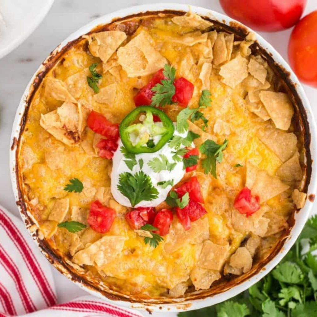 Delicious air fryer Mexican chicken casserole topped with melted cheese and garnished with fresh cilantro.