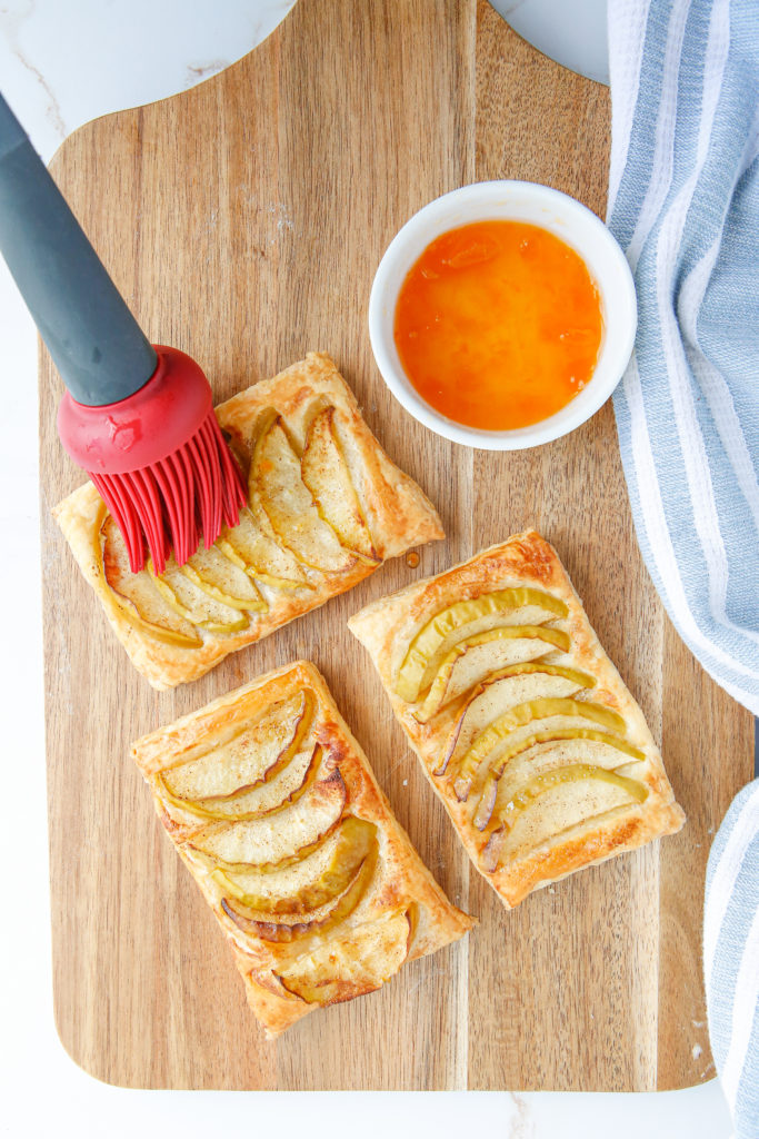Golden brown air fryer puff pastry apple tarts fresh on a plate