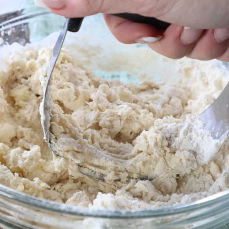  Kneading biscuit dough on a floured surface for 2-3 minutes to ensure a light and fluffy texture.