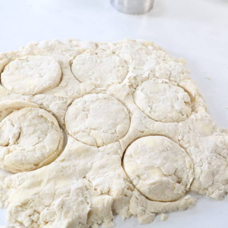 Air fryer biscuits cooking at 375°F in a single layer, turning golden brown in 8-10 minutes.