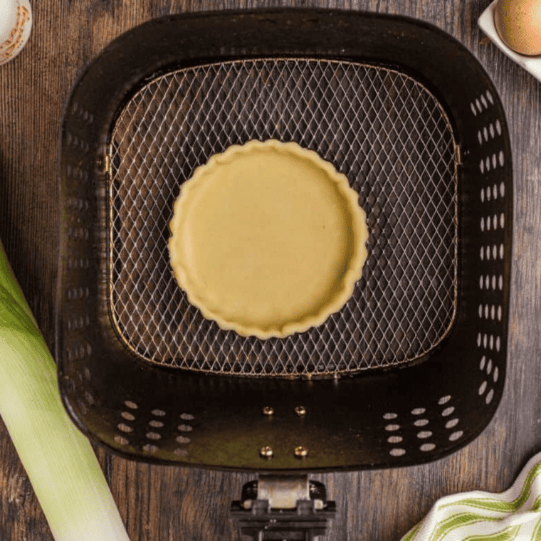 Place the pie crust in the tart pan in the air fryer, and place into the air fryer basket.