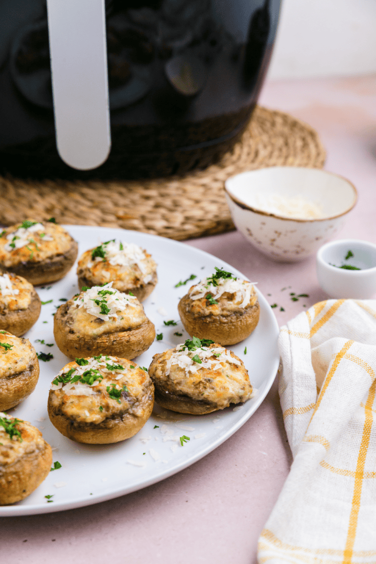 Air fryer crab stuffed mushrooms with golden brown tops and filled with crab meat mixture.