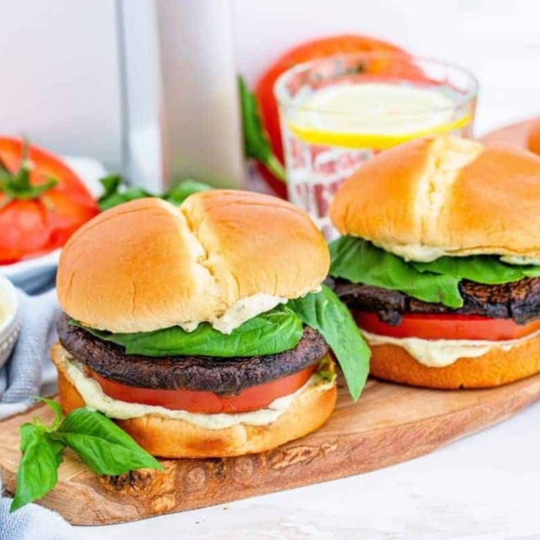 Crispy Air Fryer Portobello Mushroom Burger topped with melted cheese and fresh vegetables on a toasted bun.