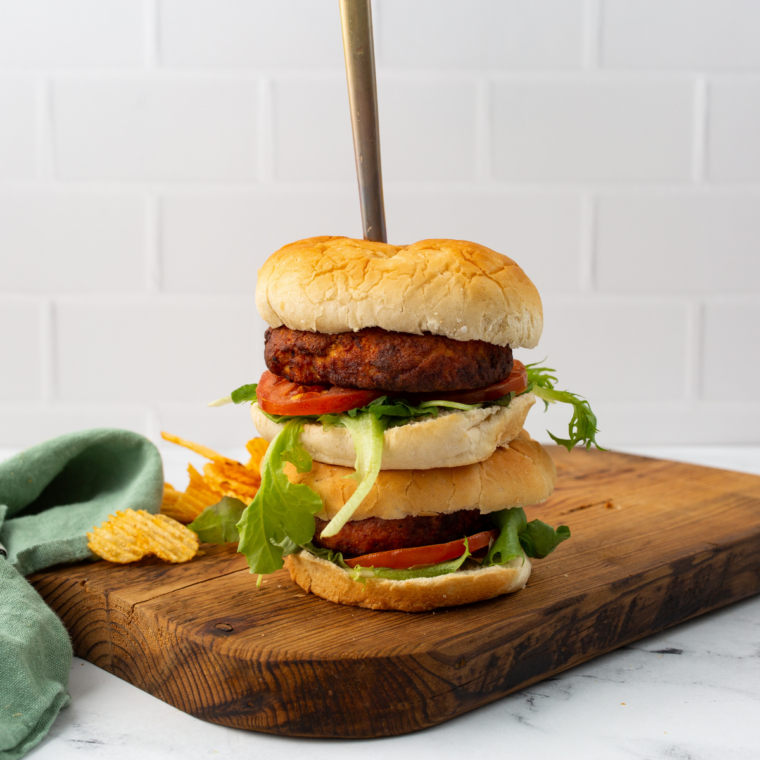 Homemade salmon burger cooking in an air fryer basket until golden brown