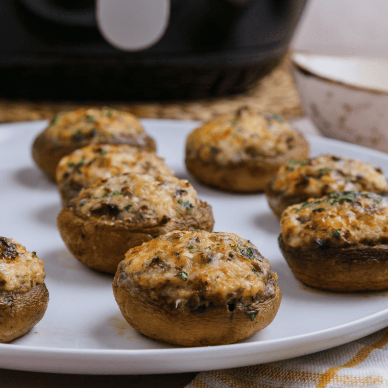Golden, crispy Air Fryer Crab Stuffed Mushrooms filled with a creamy, flavorful crab mixture, served on a white plate.