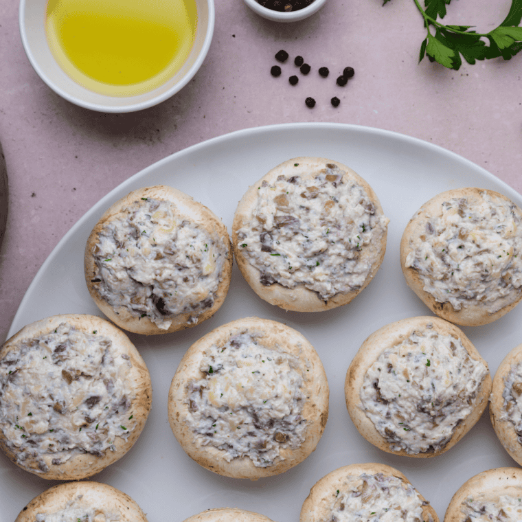 Stuffed mushroom caps filled with a creamy crab mixture, packed and ready for air frying.