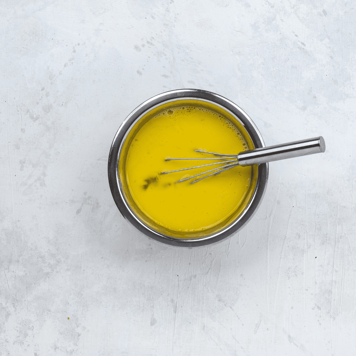 Whisking eggs, milk, salt, and black pepper in a small bowl until frothy.