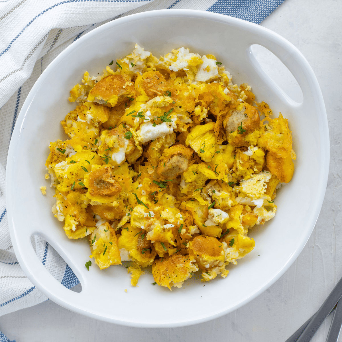 Homemade Chick-Fil-A Breakfast Bowl with scrambled eggs, crispy chicken, tater tots, and cheese
