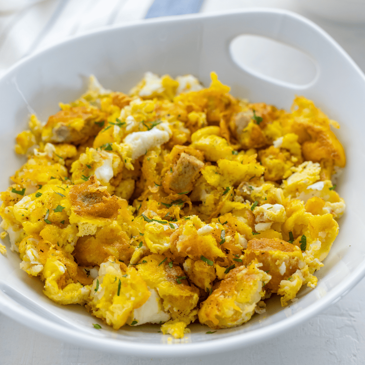Homemade Chick-Fil-A Breakfast Bowl with scrambled eggs, crispy chicken, and fresh toppings