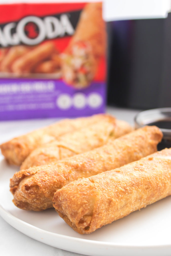dipping cooked egg roll in sauce