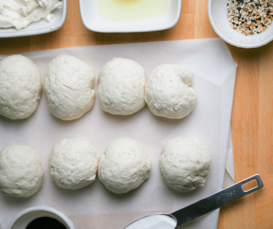 Key components for making Air Fryer Bantam Bagels: frozen rolls, rich cream cheese, flavorful shredded cheese, and your choice of seasoning