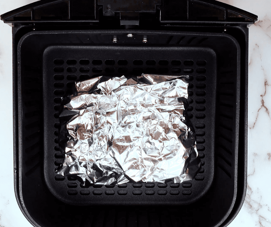 Wrapping Foil Packs: Foil packs being wrapped tightly around the potato mixture. and Air Frying Foil Packs: Foil packs placed in the air fryer basket, ready to cook.