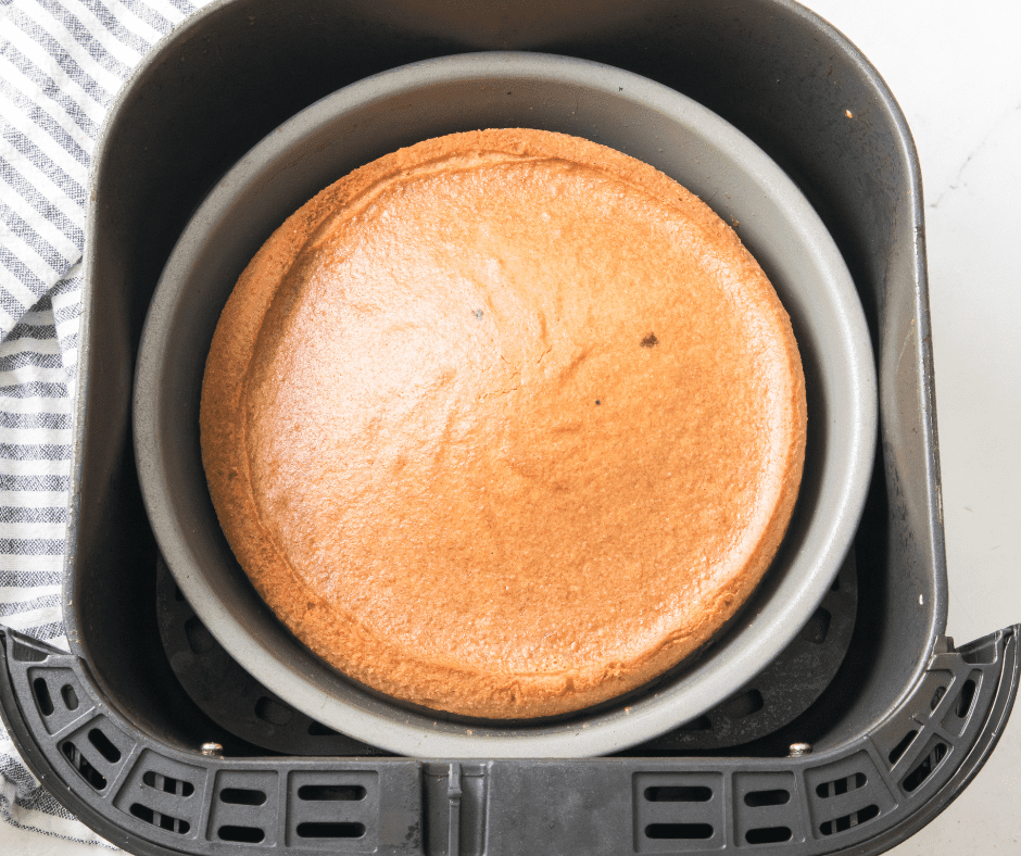 Pouring vanilla cake batter into a prepared pan before air frying at 330°F for 25–30 minutes.