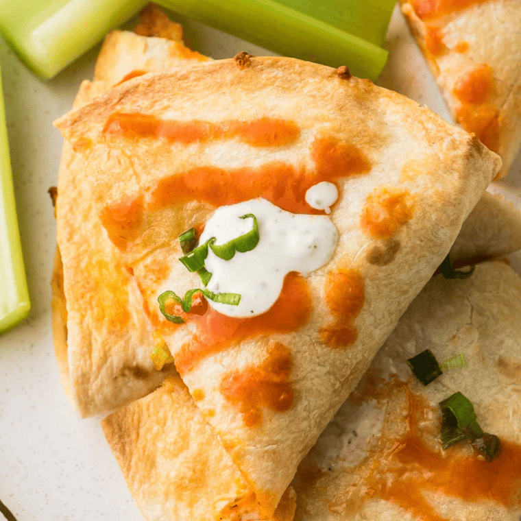 Air fryer Southwest chicken quesadilla sliced into wedges with melted cheese and seasoned chicken filling.