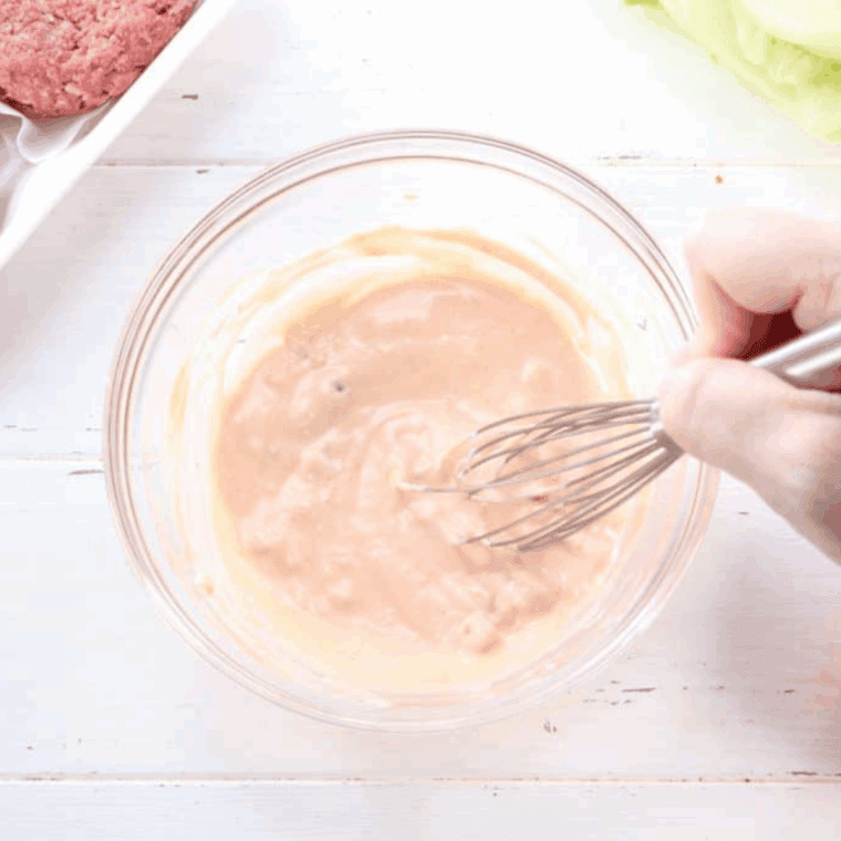 Whisk mixing In-N-Out spread ingredients in a bowl until smooth and creamy.