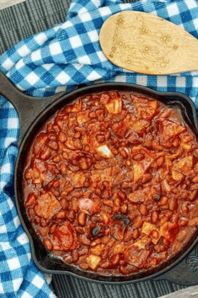 Homemade KFC-style BBQ baked beans in a bowl, featuring a rich, smoky sauce and crispy bacon pieces.