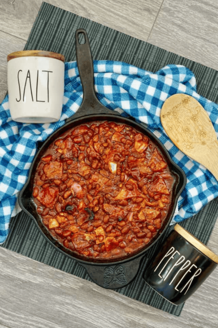 Bowl of homemade KFC-style BBQ baked beans with a rich, smoky sauce, served as a classic barbecue side dish.