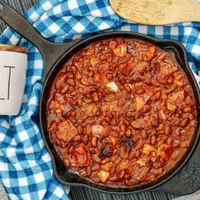 A bowl of KFC-style BBQ baked beans, rich in smoky flavors, served as a perfect side dish.
