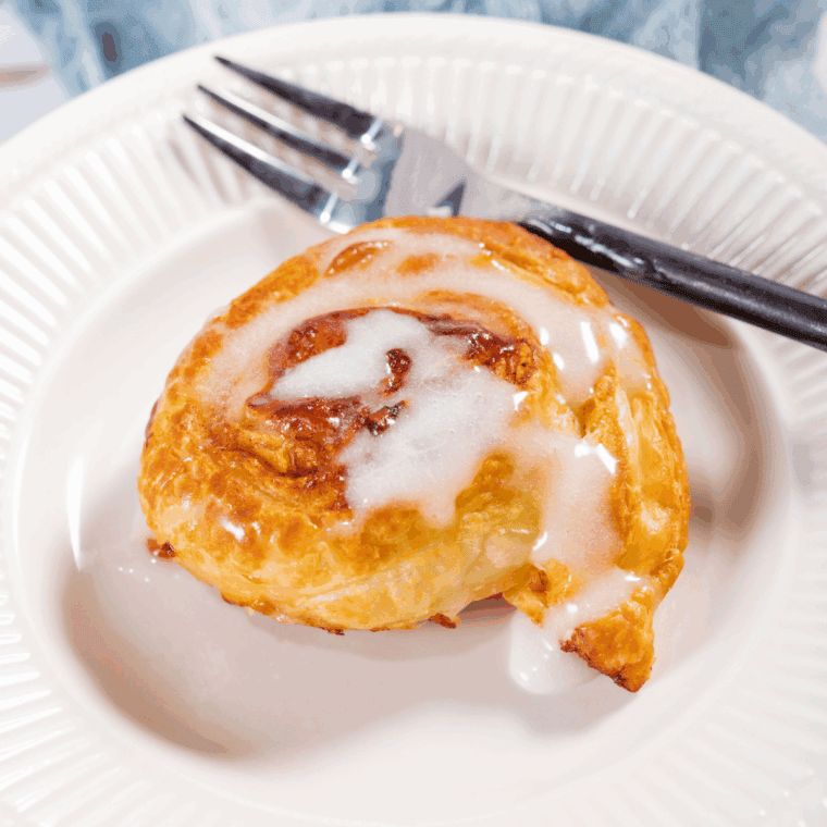 Homemade Panera cinnamon roll with rich icing drizzle on top.