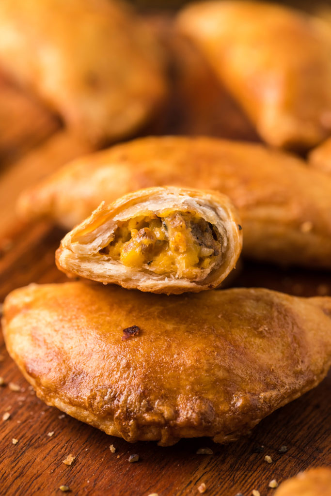 Serving Air Fryer Breakfast Empanadas on a plate with dipping sauce.