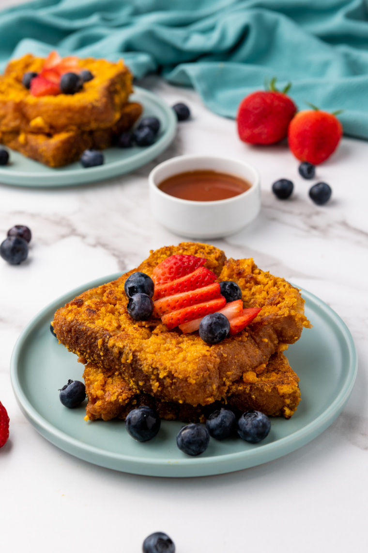 Air fryer Captain Crunch French toast slices, golden and crispy, served with syrup on a plate