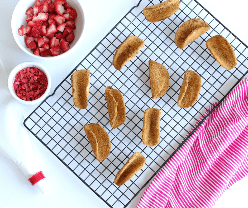 Golden air-fried taco shells filled with strawberry cheesecake and diced strawberries