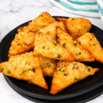 Air fryer frozen shrimp toast on a white plate with sweet chili dipping sauce