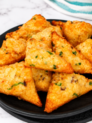 Air fryer frozen shrimp toast on a white plate with sweet chili dipping sauce