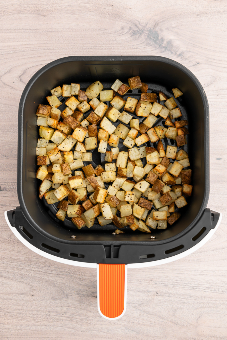 Crispy golden Simply Potatoes finished in the air fryer basket