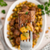 Close-up of tender steak bites alongside golden crispy potatoes