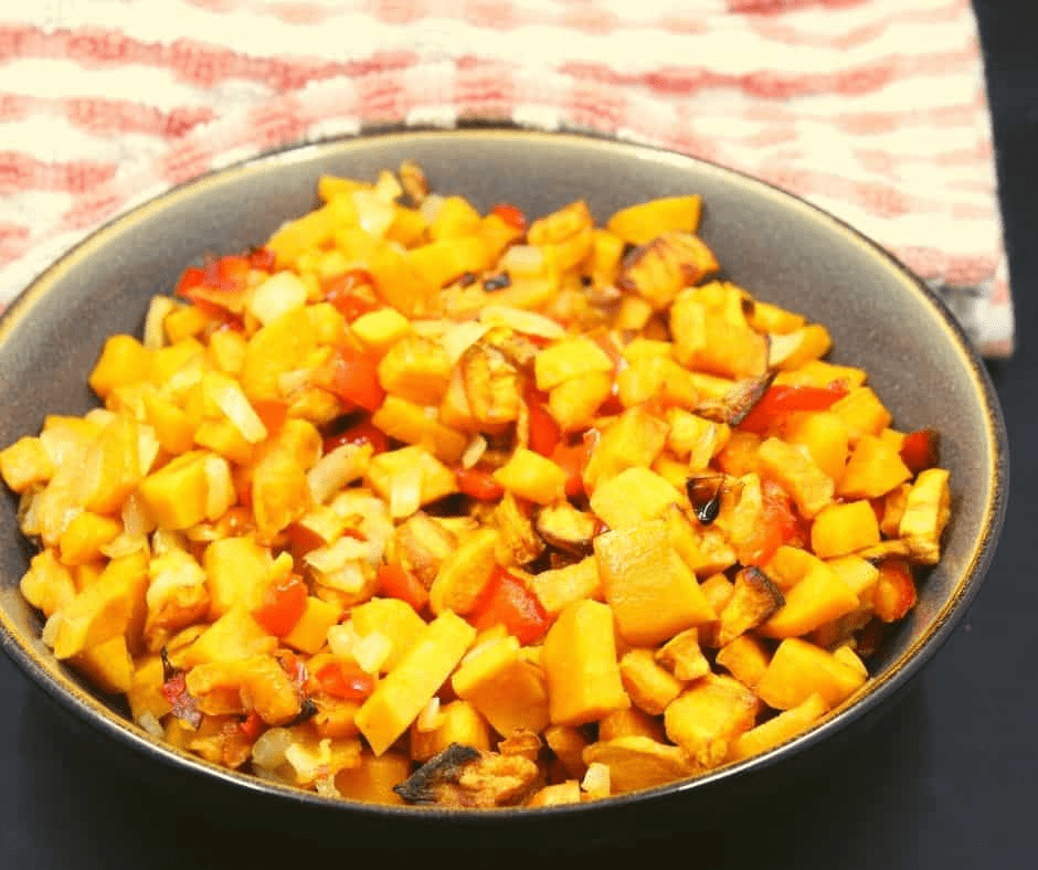 Air Fryer Sweet Potato Hash with crispy sweet potatoes, bell peppers, and onions, served in a skillet.