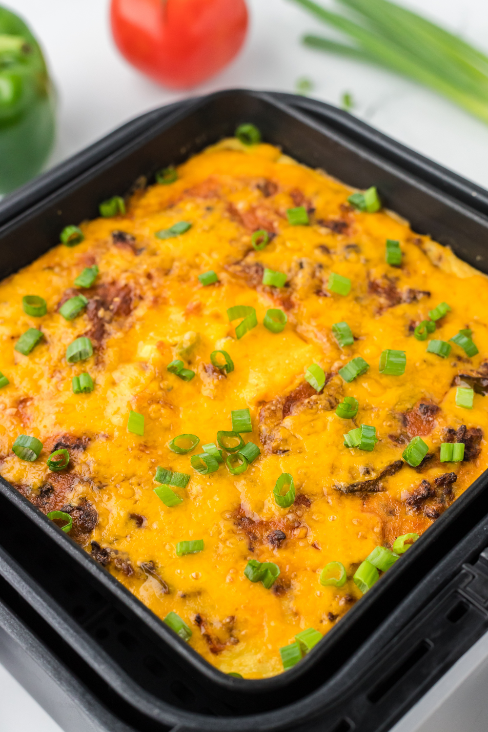 Delicious Air Fryer Taco Casserole with ground beef, veggies, and melted cheese