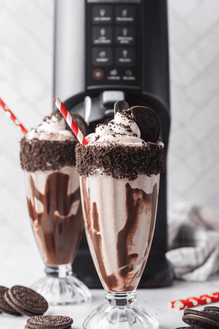 Jar of homemade copycat Hershey’s chocolate syrup with spoon and ice cream drizzle