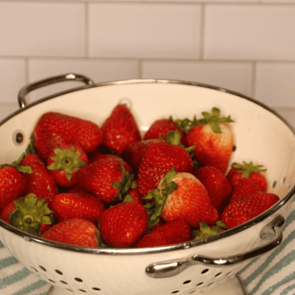 Bowl of fresh strawberries in a white bowl.