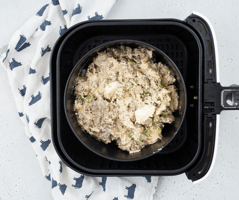 Air Fryer Philly Cheesesteak Dip cooking in the air fryer, bubbling and golden.