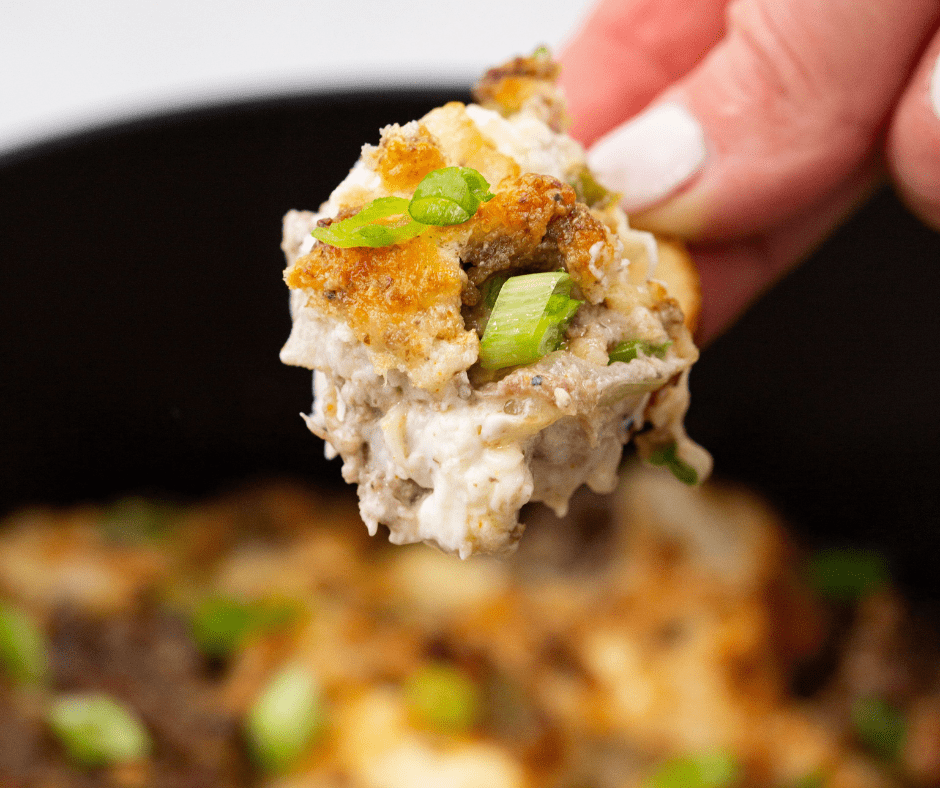 Scoop of Air Fryer Philly Cheesesteak Dip on a tortilla chip, ready to enjoy.