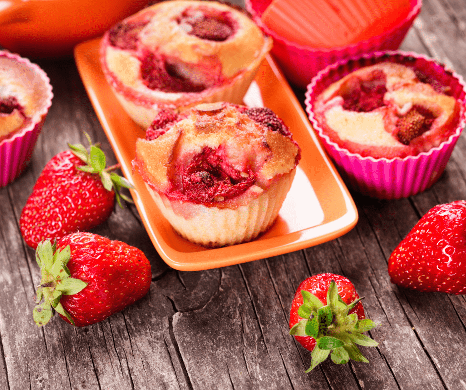 Golden, fluffy air fryer strawberry muffins with fresh strawberry pieces