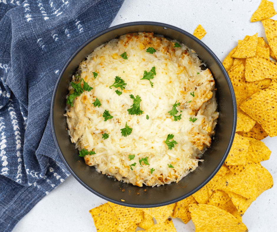 White Chicken Chili Dip served in a skillet, ready to be enjoyed with chips.