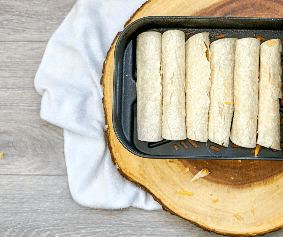 Preheat the Air Fryer:
Preheat your air fryer to 400 degrees F (190°C) for 1-2 minutes. Preheating ensures even cooking and a crispy texture.
Lightly Coat with Cooking Spray (Optional):
While this step is optional, lightly spraying the taquitos with cooking spray can help them become even crispier. You can skip this step if you prefer.
Arrange in the Air Fryer:
Place taquitos in a single layer in the air fryer basket or on the air fryer tray. Avoid overcrowding to allow proper air circulation. If your air fryer is small, you may need to cook them in batches.
Air Fry the Taquitos:
Set the cooking temperature to 400 degrees Fahrenheit, and the cooking time for 8-10 minutes, shaking the basket or flipping them halfway through the cooking process to ensure even browning.
Optional Toppings:
If you'd like to add shredded cheese, sprinkle it on the taquitos during the last 2 minutes of cooking. This allows the cheese to melt and become gooey.
Check for Crispy Perfection:
The taquitos are done when they are golden brown and crispy. Keep an eye on them during the last few minutes to avoid overcooking.
Serving
Remove the taquitos from the air fryer and let them cool for a minute or two. They are best enjoyed while still hot and crispy. Garnish the taquitos with fresh cilantro, lime wedges, avocado, jalapeño, or other toppings of your choice for added flavor and presentation. Season the taquitos with a pinch of salt and freshly ground black pepper to taste! Serve your hot and crispy air fryer frozen taquitos with your favorite dipping sauces or toppings for a delicious and convenient snack or meal.