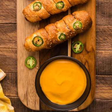 Applebee's Brew Pub Pretzels and beer cheese dip served on a wooden board